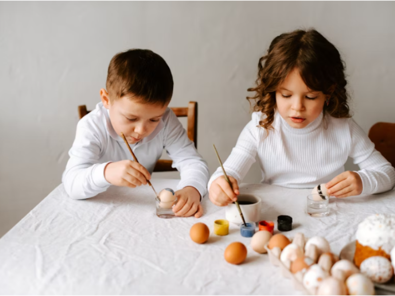 Children making colorful popsicle stick puppets and paper plate animals at home