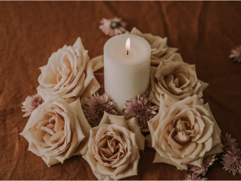 DIY soy wax candles in glass jars with essential oils and dried herbs for decoration