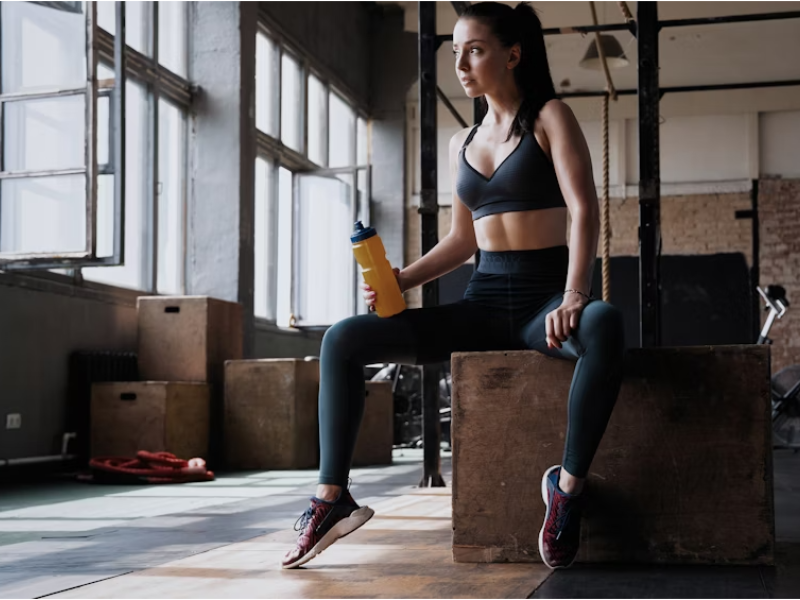 Woman in high-waisted black workout leggings exercising outdoors
